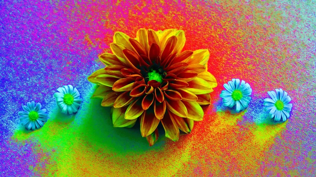 A vibrant close-up of a large orange and yellow flower with a green center, surrounded by three smaller blue and white flowers. The background is a dazzling blend of colors, including shades of purple, blue, green, and red, resembling a textured paint effect. This image emphasizes the importance of color in wall paint, showcasing the beauty and impact that a diverse palette can have in interior design.